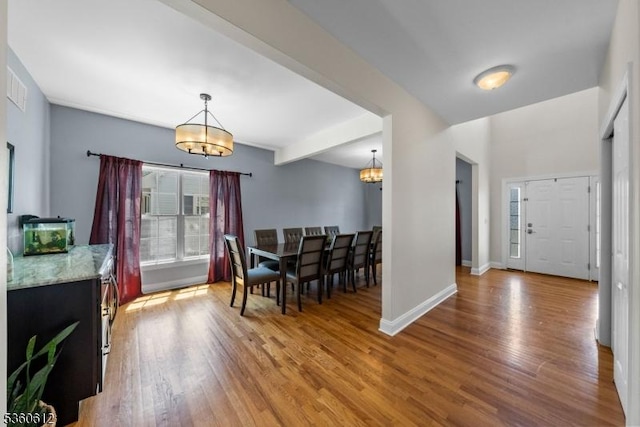 143 Oak St, Bridgewater Twp, NJ 08807 - dining room featuring a chandelier, wood finished floors, and baseboards
