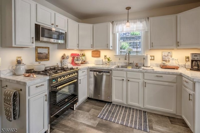 51 E Main St, High Bridge Boro, NJ 08829 - kitchen featuring appliances with stainless steel finishes, a sink, white cabinetry, light countertops, and hanging light fixtures