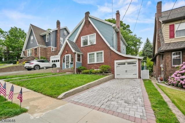 126 Beech St, Nutley Twp, NJ 07110 - tudor home with a front lawn, driveway, brick siding, and an attached garage