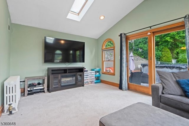 126 Beech St, Nutley Twp, NJ 07110 - carpeted living room with vaulted ceiling, healthy amount of natural light, a skylight, a glass covered fireplace, and baseboards