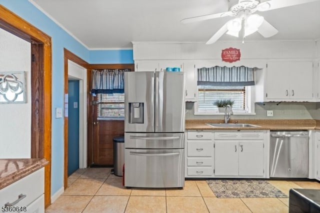 126 Beech St, Nutley Twp, NJ 07110 - kitchen featuring appliances with stainless steel finishes, a sink, ornamental molding, white cabinetry, and light tile patterned floors