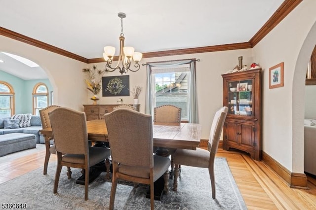 126 Beech St, Nutley Twp, NJ 07110 - dining space featuring arched walkways, a chandelier, plenty of natural light, light wood-type flooring, and ornamental molding