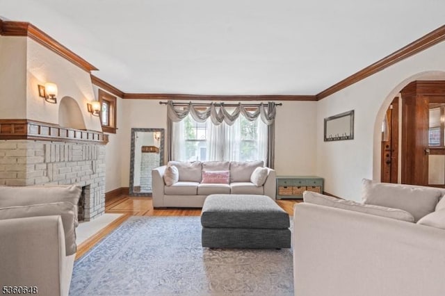 126 Beech St, Nutley Twp, NJ 07110 - living room with ornamental molding, arched walkways, wood finished floors, baseboards, and a brick fireplace