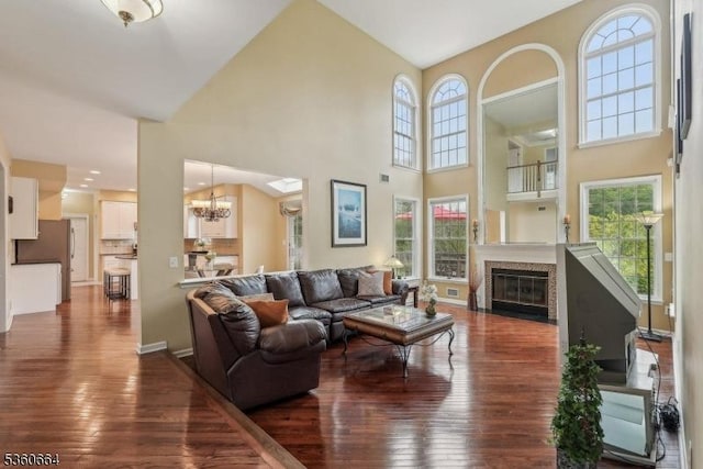 9 Labaw Way, Montgomery Twp, NJ 08502 - living area featuring dark wood-style flooring, a chandelier, a towering ceiling, a fireplace with flush hearth, and baseboards