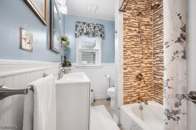 126 Smith Rd, Franklin Twp, NJ 08873 - bathroom featuring vanity, shower / tub combo with curtain, wainscoting, and toilet