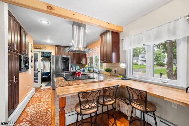 126 Smith Rd, Franklin Twp, NJ 08873 - kitchen featuring stainless steel appliances, wood counters, tasteful backsplash, island exhaust hood, and a kitchen breakfast bar