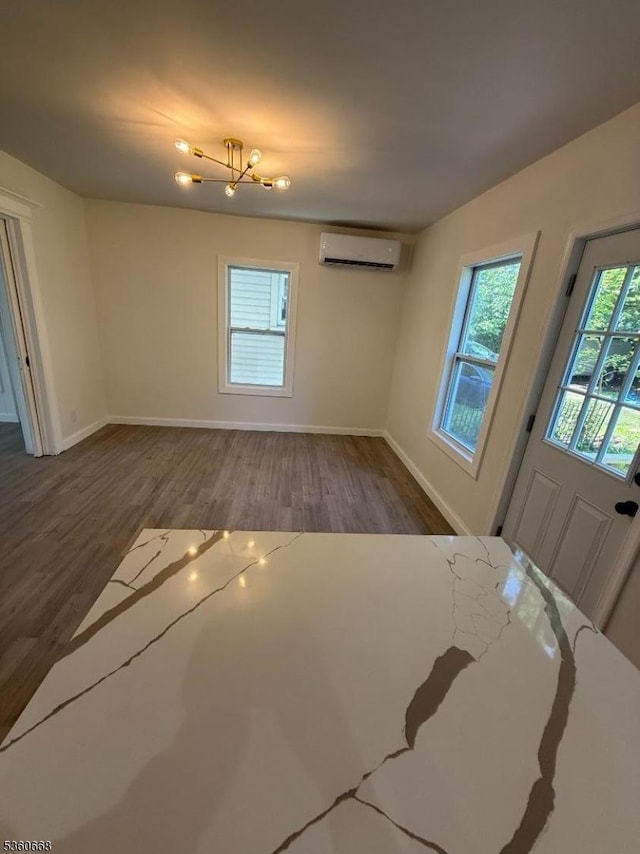 67 Mead St, Newark City, NJ 07106 - unfurnished living room featuring a wall mounted air conditioner, wood finished floors, baseboards, and a chandelier