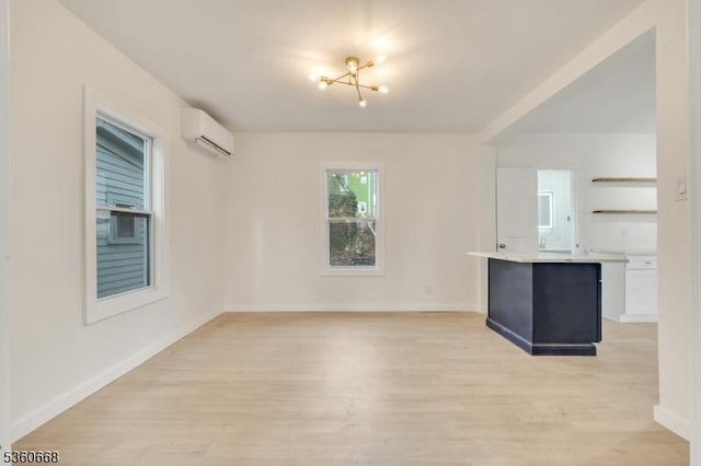 67 Mead St, Newark City, NJ 07106 - unfurnished living room with a wall mounted air conditioner, light wood-style floors, baseboards, and a chandelier