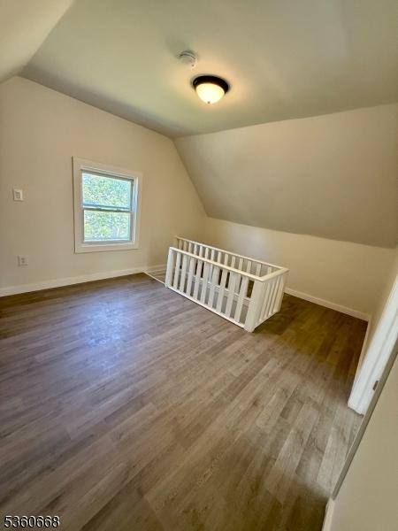 67 Mead St, Newark City, NJ 07106 - bonus room featuring lofted ceiling, dark wood-style flooring, and baseboards