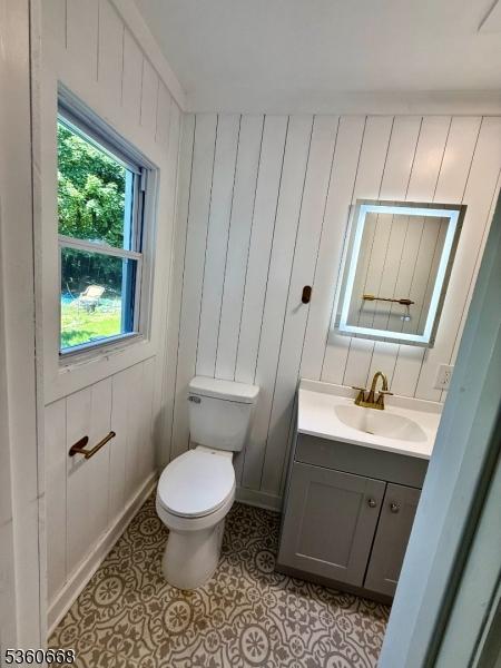 67 Mead St, Newark City, NJ 07106 - half bath featuring vanity, toilet, tile patterned flooring, and baseboards