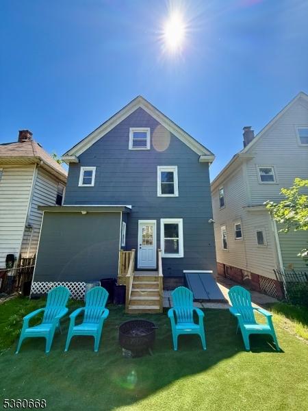 67 Mead St, Newark City, NJ 07106 - back of house with an outdoor fire pit and a yard