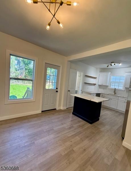 67 Mead St, Newark City, NJ 07106 - kitchen featuring light countertops, a kitchen island, a chandelier, and healthy amount of natural light