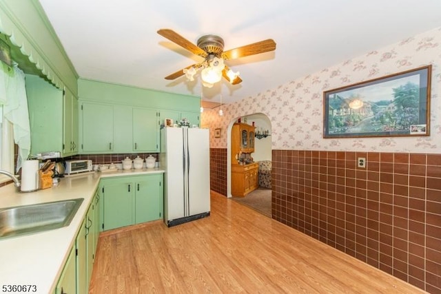 291 Germantown Rd, West Milford Twp, NJ 07480 - kitchen featuring freestanding refrigerator, a sink, wallpapered walls, a ceiling fan, and light countertops