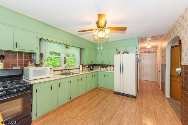 291 Germantown Rd, West Milford Twp, NJ 07480 - kitchen with white appliances, a sink, arched walkways, light wood-type flooring, and light countertops