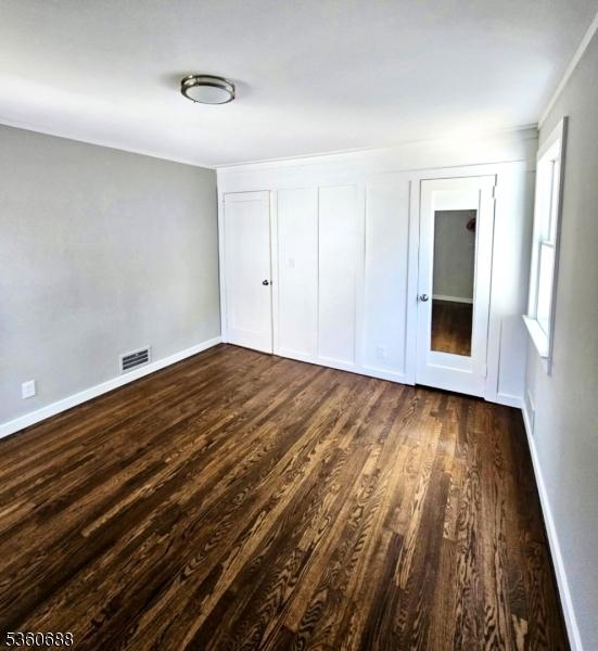 36 Webster Ave, Summit City, NJ 07901 - unfurnished bedroom with dark wood-style flooring and baseboards
