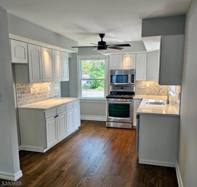 36 Webster Ave, Summit City, NJ 07901 - kitchen with stainless steel appliances, a sink, baseboards, and decorative backsplash