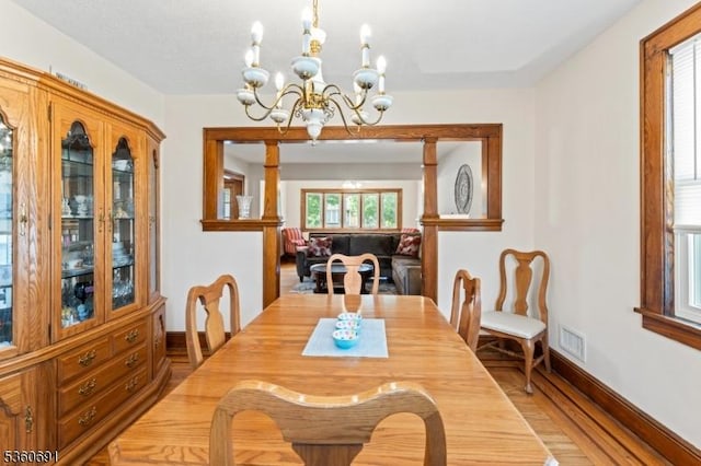 421 Lake Ave, Lyndhurst Twp, NJ 07071 - dining room with baseboards, light wood-style floors, and a chandelier