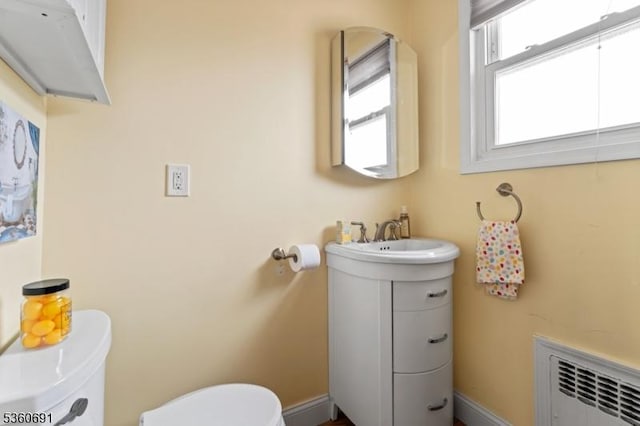 421 Lake Ave, Lyndhurst Twp, NJ 07071 - half bath featuring radiator heating unit, toilet, vanity, and baseboards