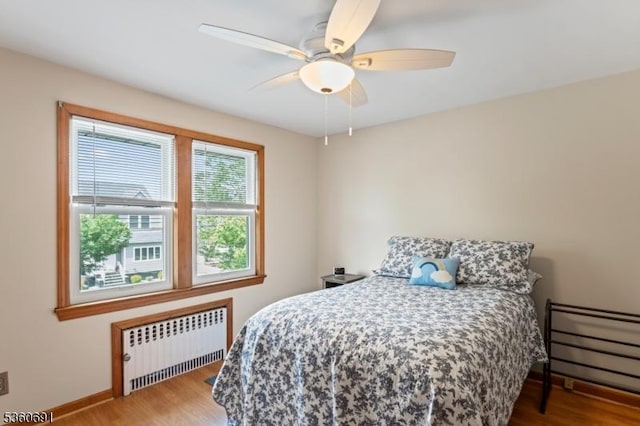 421 Lake Ave, Lyndhurst Twp, NJ 07071 - bedroom with radiator, baseboards, wood finished floors, and a ceiling fan