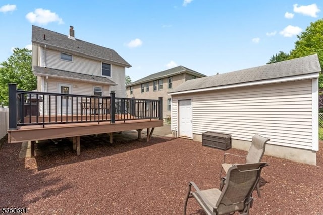 421 Lake Ave, Lyndhurst Twp, NJ 07071 - back of house with a wooden deck, a chimney, and an outbuilding