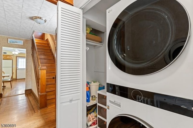 421 Lake Ave, Lyndhurst Twp, NJ 07071 - washroom with estacked washer and dryer, wood finished floors, and ceiling fan