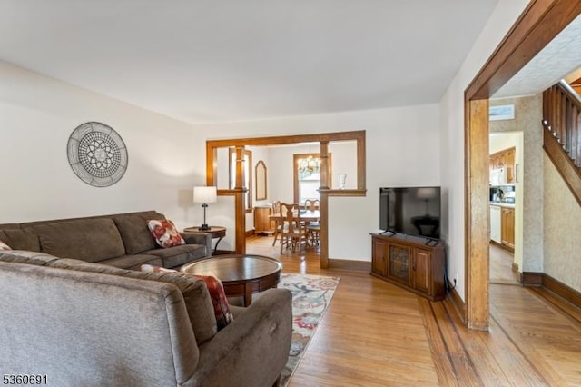421 Lake Ave, Lyndhurst Twp, NJ 07071 - living area with light wood-type flooring, stairs, baseboards, and a chandelier