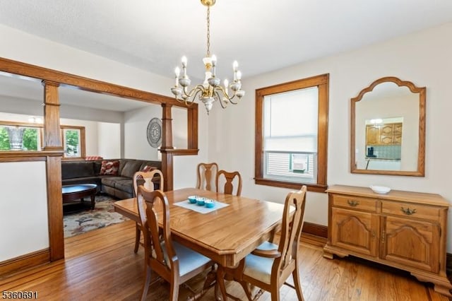 421 Lake Ave, Lyndhurst Twp, NJ 07071 - dining area with light wood finished floors, a chandelier, and baseboards