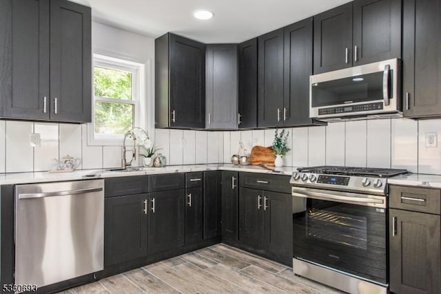 35 Ellis Ave, Irvington Twp, NJ 07111 - kitchen with stainless steel appliances, light wood-style flooring, dark cabinetry, and recessed lighting