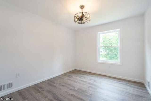 35 Ellis Ave, Irvington Twp, NJ 07111 - spare room with a chandelier and wood finished floors