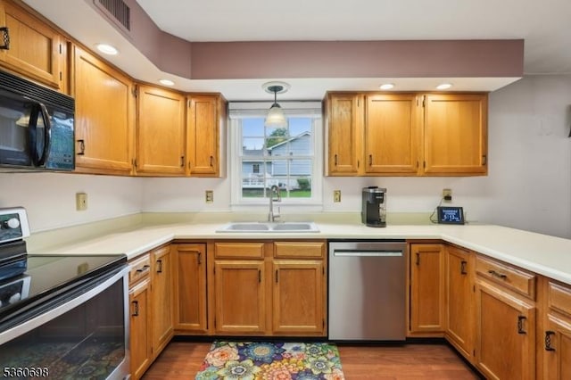 7 Michael Ct, Green Twp, NJ 07860 - kitchen with stainless steel appliances, a sink, light countertops, wood finished floors, and recessed lighting