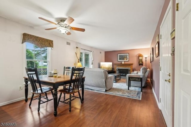 7 Michael Ct, Green Twp, NJ 07860 - dining area with wood finished floors, a ceiling fan, a glass covered fireplace, and baseboards
