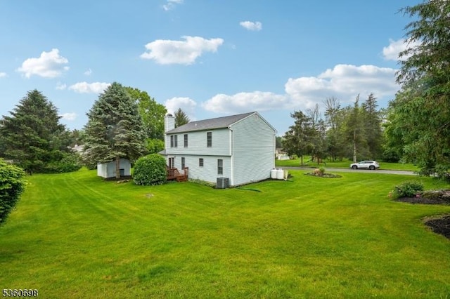 7 Michael Ct, Green Twp, NJ 07860 - rear view of property featuring a chimney, a lawn, and central AC unit
