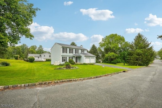 7 Michael Ct, Green Twp, NJ 07860 - view of front facade featuring asphalt driveway, a front yard, an attached garage, and a chimney