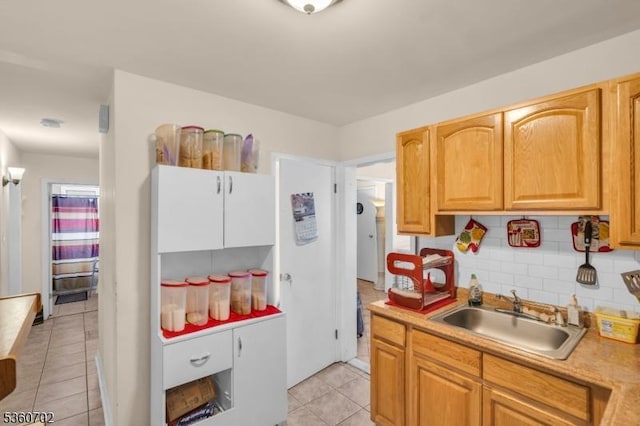 314 Fitzpatrick St, Hillside Twp, NJ 07205 - kitchen featuring a sink, light countertops, light tile patterned flooring, and decorative backsplash