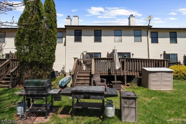 424 Willow Ct, Raritan Twp, NJ 08822 - back of property featuring stairs, a deck, a chimney, and a yard