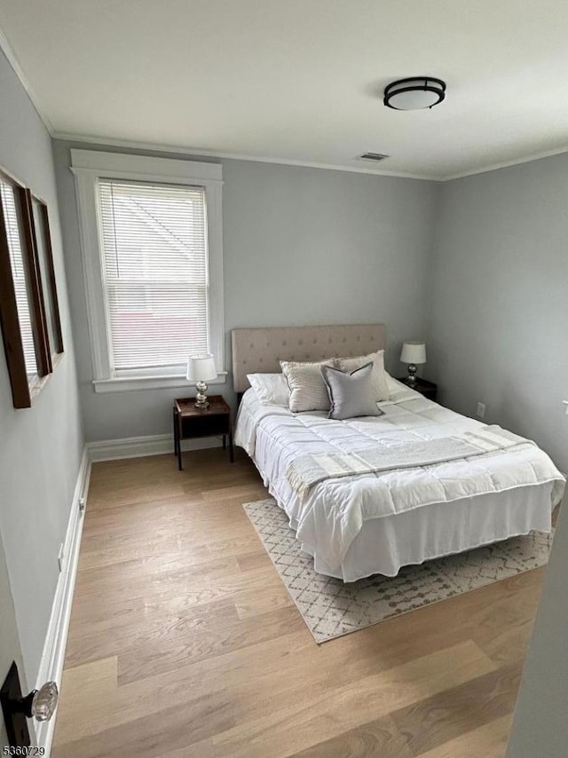 96 Franklin Ave, Maplewood Twp, NJ 07040 - bedroom featuring light wood-type flooring, ornamental molding, and baseboards