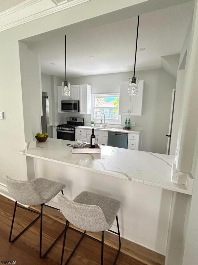 96 Franklin Ave, Maplewood Twp, NJ 07040 - kitchen with stainless steel appliances, a sink, white cabinetry, dark wood finished floors, and a peninsula
