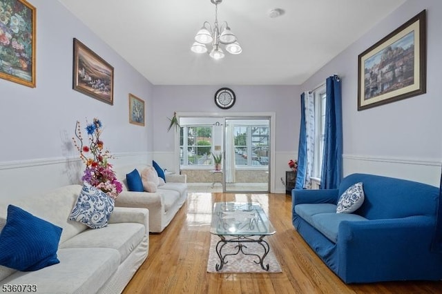 548 Jefferson Ave, Elizabeth City, NJ 07201 - living area with a chandelier, a wainscoted wall, and wood finished floors