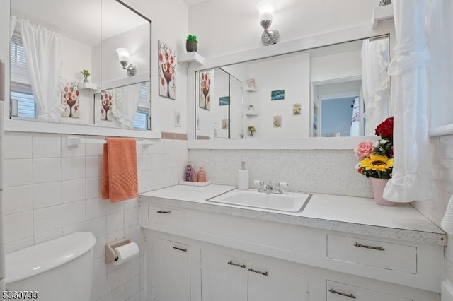 548 Jefferson Ave, Elizabeth City, NJ 07201 - bathroom featuring tile walls, vanity, toilet, and plenty of natural light