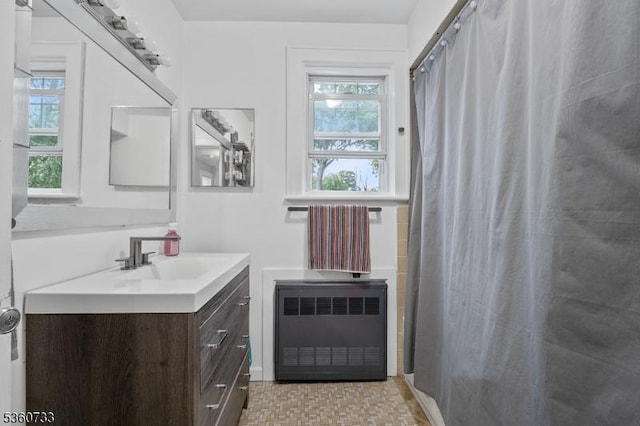548 Jefferson Ave, Elizabeth City, NJ 07201 - bathroom featuring radiator, vanity, and curtained shower