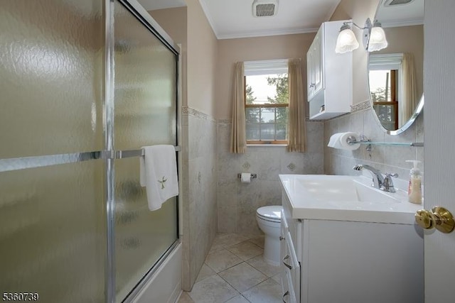 455 Rte 206, Andover Twp, NJ 07860 - bathroom featuring tile patterned flooring, vanity, toilet, combined bath / shower with glass door, and tile walls
