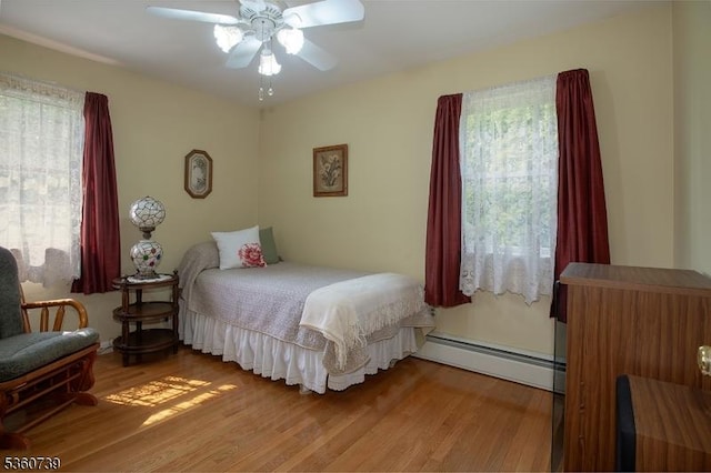 455 Rte 206, Andover Twp, NJ 07860 - bedroom with multiple windows, a baseboard radiator, and wood finished floors