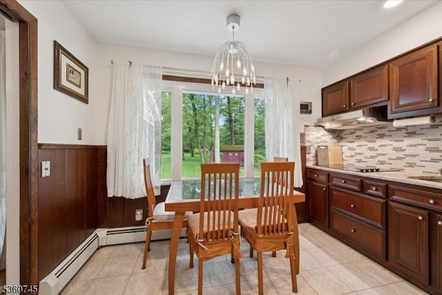 42 Wildwood Ter, Watchung Boro, NJ 07069 - dining area featuring a chandelier, light tile patterned flooring, a wainscoted wall, a baseboard heating unit, and wooden walls