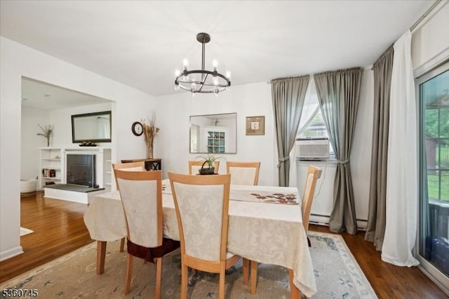 42 Wildwood Ter, Watchung Boro, NJ 07069 - dining area featuring a chandelier, wood finished floors, and a glass covered fireplace