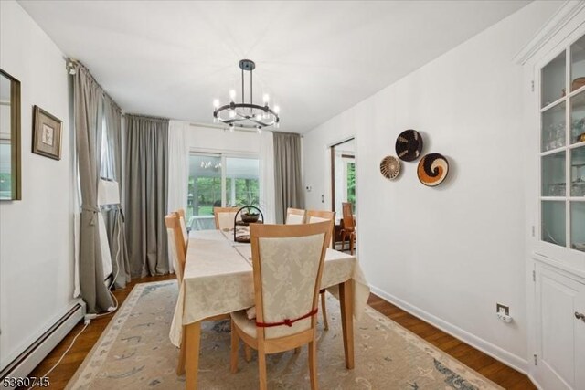 42 Wildwood Ter, Watchung Boro, NJ 07069 - dining area featuring baseboard heating, a chandelier, and wood finished floors