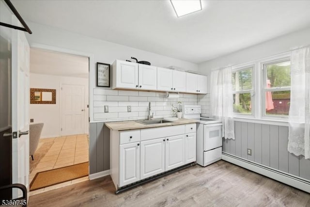 42 Wildwood Ter, Watchung Boro, NJ 07069 - kitchen featuring electric range, a baseboard radiator, white cabinets, light countertops, and backsplash