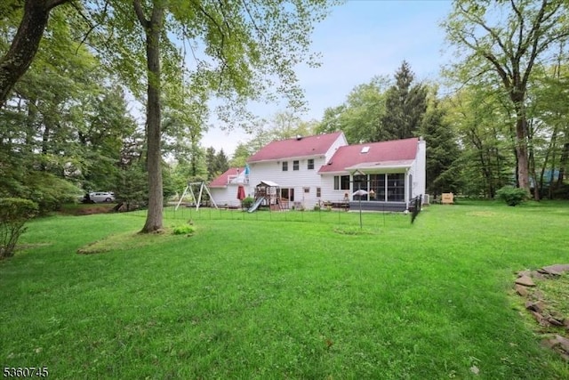 42 Wildwood Ter, Watchung Boro, NJ 07069 - back of property featuring a lawn, a sunroom, and a chimney