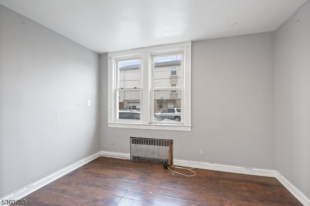 30-32 Geneva St, Elizabeth City, NJ 07206 - spare room with radiator, hardwood / wood-style floors, and baseboards