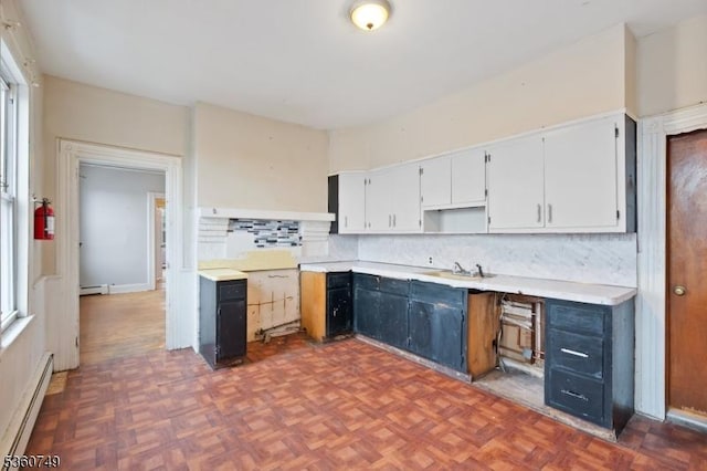 30-32 Geneva St, Elizabeth City, NJ 07206 - kitchen featuring a baseboard heating unit, backsplash, white cabinetry, and light countertops