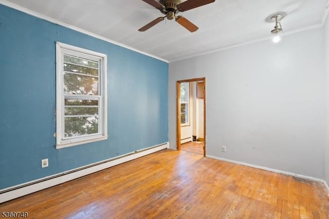 30-32 Geneva St, Elizabeth City, NJ 07206 - spare room with baseboard heating, ornamental molding, wood finished floors, a ceiling fan, and baseboards